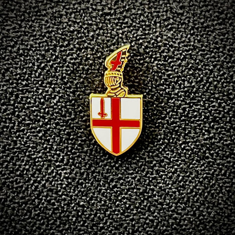 City of London shield lapel pin on black textured background